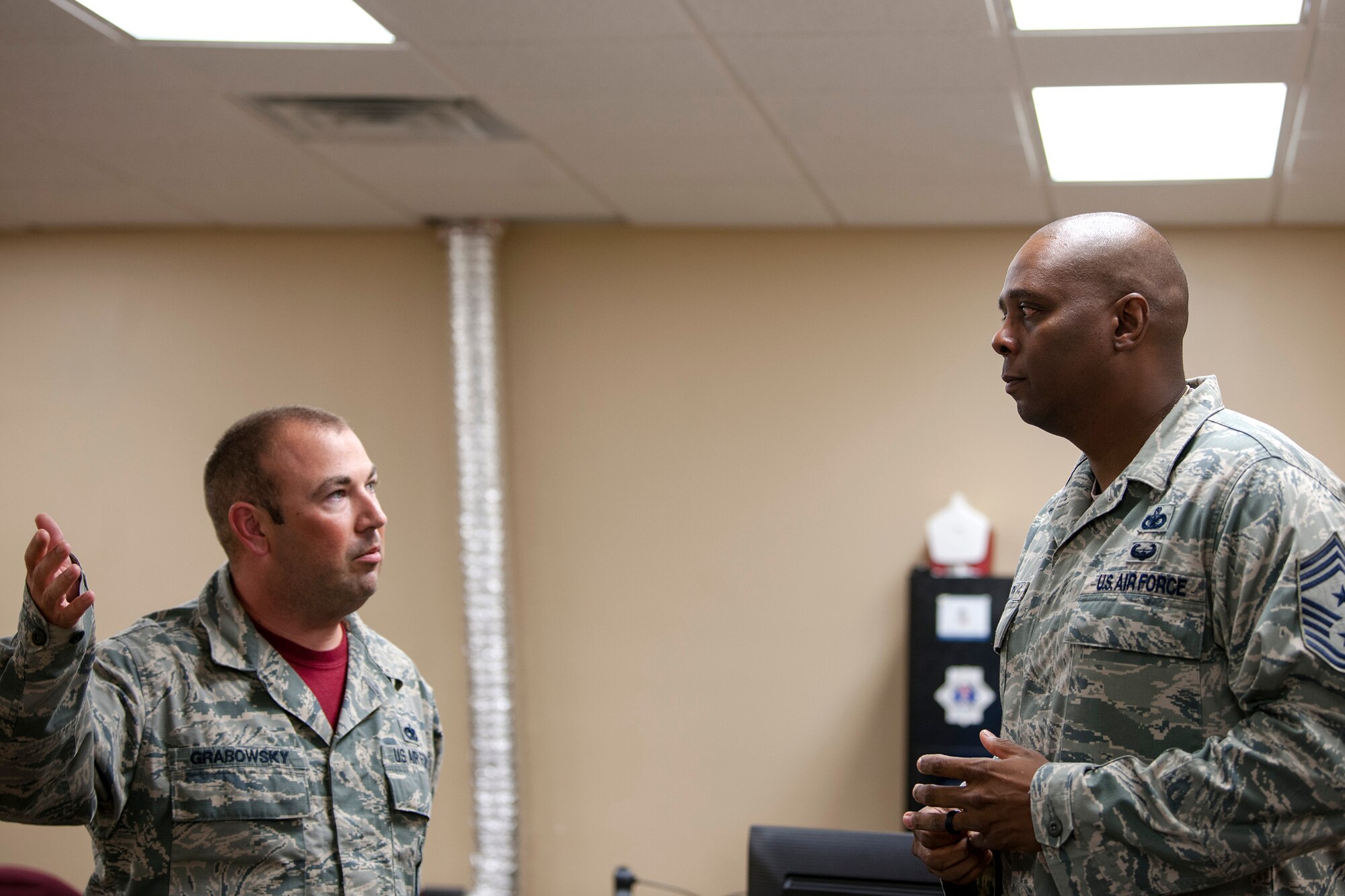 Tech. Sgt. Kevin Grabowsky, left, 23d Maintenance Squadron (MXS) NCO in charge of munitions control, talks with Chief Master Sgt. James Allen, 23d Wing command chief, during an immersion, Aug. 10, 2018, at Moody Air Force Base, Ga. Allen learned about the Airmen and heard their viewpoints and feedback regarding the operations of the 23d MXS. (U.S. Air Force photo by Airman Taryn Butler)