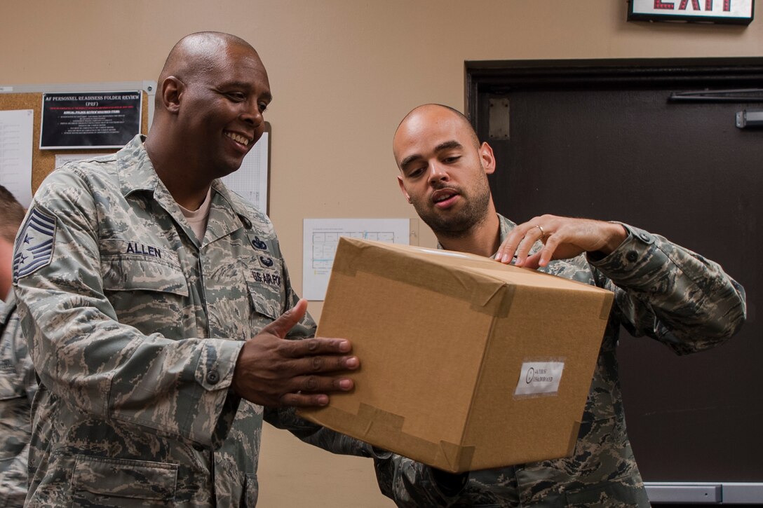 Tech. Sgt. Justin Skinner, right, 23d Maintenance Squadron (MXS) stock pile management production supervisor, inspects a box with Chief Master Sgt. James Allen, 23d Wing command chief, during an immersion, Aug. 10, 2018, at Moody Air Force Base, Ga. Allen learned about the Airmen and heard their viewpoints and feedback regarding the operations of the 23d MXS. (U.S. Air Force photo by Airman Taryn Butler)