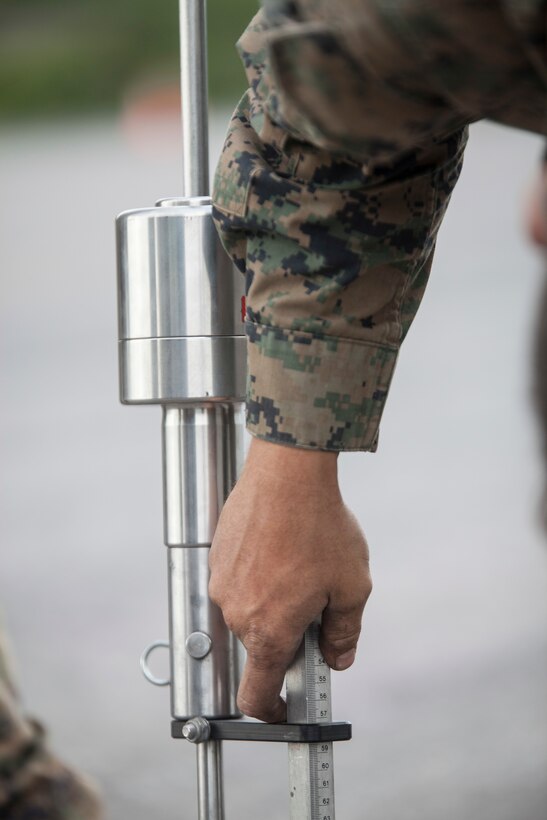 Cpl. Steve Anderson, a refueler with Marine Wing Support Squadron 471, 4th Marine Aircraft Wing uses the dynamic cone penetrometer to test the density of the 2,000-foot runway extension during Innovative Readiness Training Old Harbor, Aug. 6, 2018. The IRT program supports troops’ readiness to fight through training, while serving American communities. (U.S. Marine Corps photo by Lance Cpl. Tessa D. Watts)