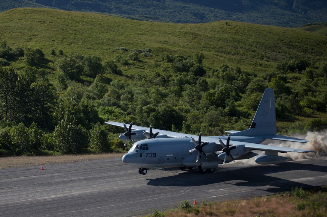 Col. Charles Moses, the commanding officer of Marine Air Group 41, 4th Marine Aircraft Wing lands a C-130 onto the newly extended runway for the first time during Innovative Readiness Training Old Harbor, Alaska, Aug. 7, 2018. This year marks the completion of the 2,000-foot extension of Old Harbor’s runway. (U.S. Marine Corps photo by Lance Cpl. Tessa D. Watts)
