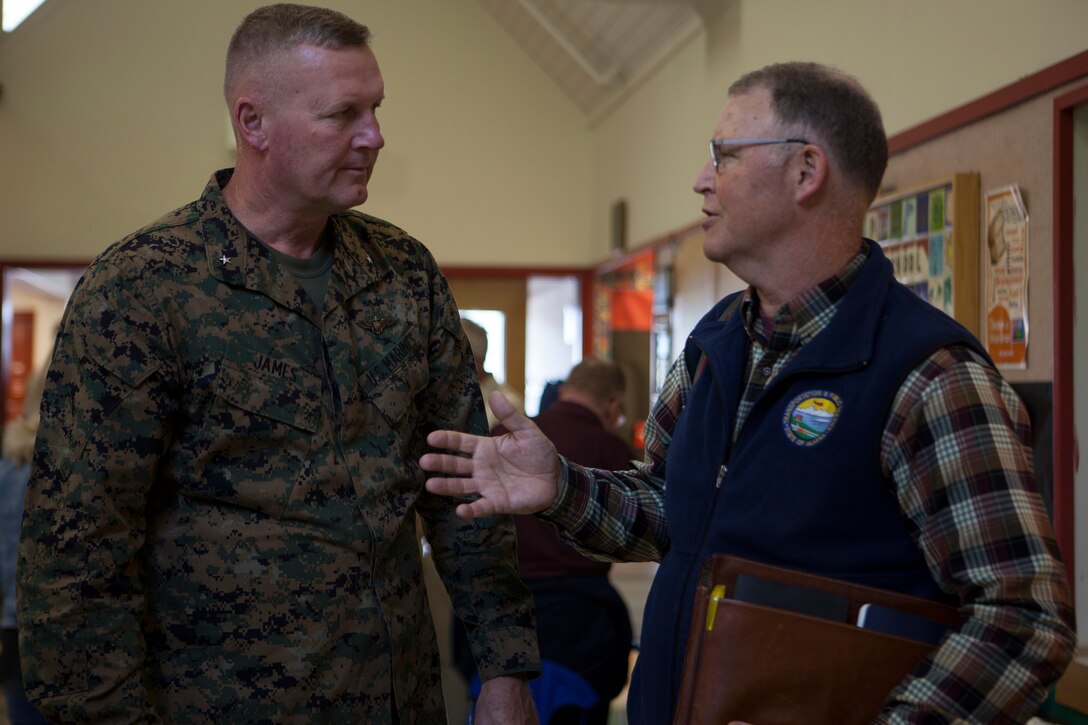 Brig. Gen. Bradley S. James, commanding general of 4th Marine Aircraft Wing and Mark A. Luiken, commissioner of the Alaska Department of Transportation and Public Facilities speak during a luncheon held at the Old Harbor School about the extended runway completed during Innovative Readiness Training Old Harbor, Alaska, Aug. 7, 2018. This year marks the completion of the 2,000-foot extension of Old Harbor’s runway. (U.S. Marine Corps photo by Lance Cpl. Tessa D. Watts)