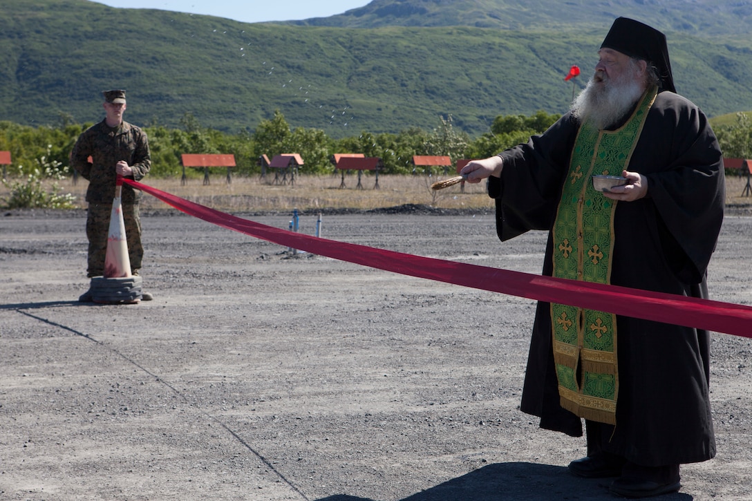 Father Loasaph, spiritual leader of the Russian Orthodox church in Old Harbor, Alaska, blesses the extended runway Aug. 7, 2018. This year marks the completion of the 2,000-foot extension of Old Harbor’s runway. (U.S. Marine Corps photo by Lance Cpl. Tessa D. Watts) (U.S. Marine Corps photo by Lance Cpl Tessa D. Watts)