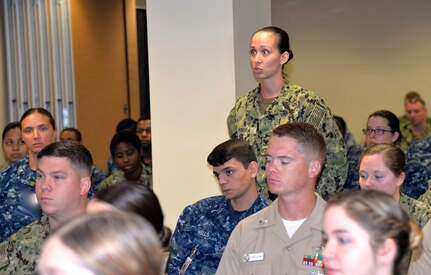Petty Officer 2nd Class Lauren Pereda, a hospital corpsman serving at Naval Health Clinic Charleston and NHCC’s career counselor, highlights the goals of NHCC’s newly created mentorship program for Navy Medicine East Command Master Chief Michael Hinkle during his visit to the clinic Aug. 7, 2018.