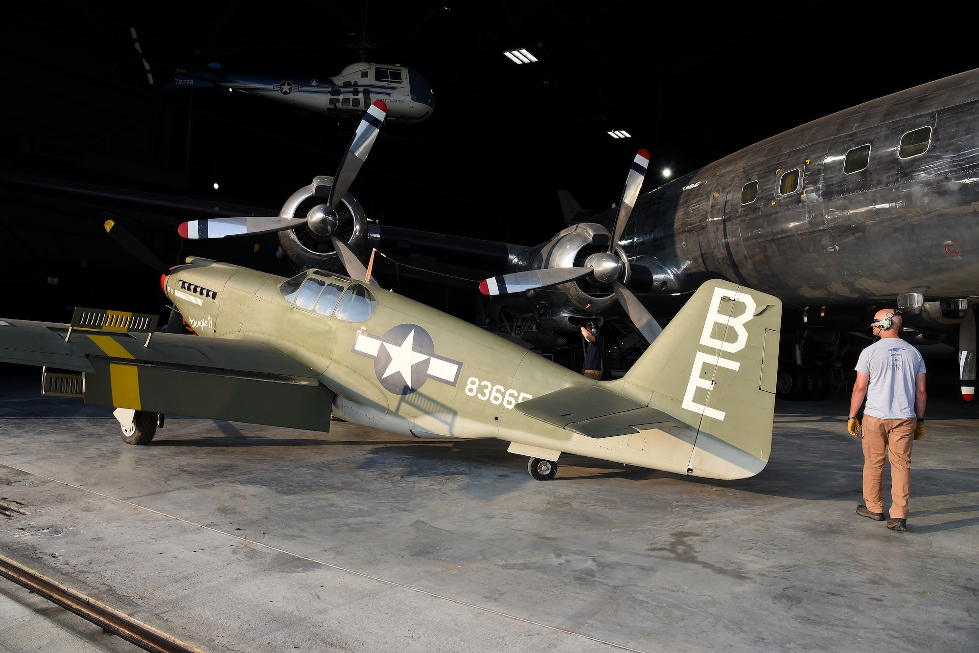 Museum restoration crews prepare to move the North American A-36A Mustang back into the WWII Gallery at the National Museum of the U.S. Air Force on Aug. 13, 2018. Several WWII era aircraft were temporarily placed throughout the museum to provide adequate space for the Memphis Belle exhibit opening events. (U.S. Air Force photo by Ken LaRock)