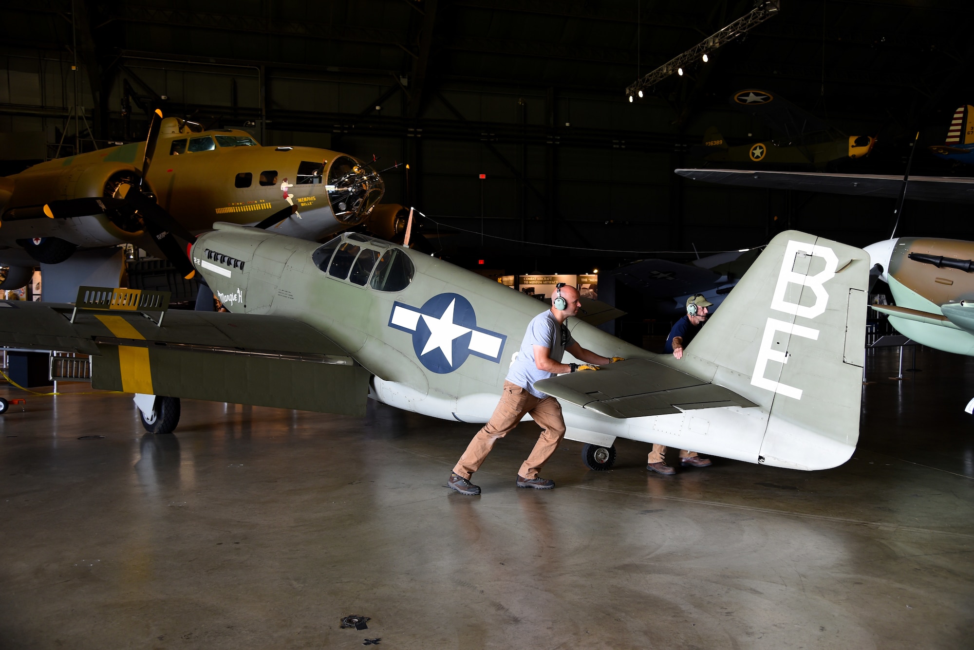 Museum restoration crews move the North American A-36A Mustang back into the WWII Gallery at the National Museum of the U.S. Air Force on Aug. 13, 2018. Several WWII era aircraft were temporarily placed throughout the museum to provide adequate space for the Memphis Belle exhibit opening events. (U.S. Air Force photo by Ken LaRock)