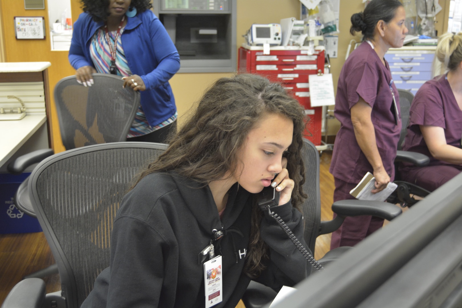 Maleigha Boudy, answers phone calls at the front desk in Ante-Partum Aug. 1. Boudy participated in the 2018 Youth Volunteer Program at Brooke Army Medical Center.