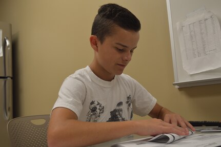 Cody Reed, a youth volunteer works for Uniform Business Office, folds flyers July 27 as part of the 2018 Youth Volunteer Program at Brooke Army Medical Center.