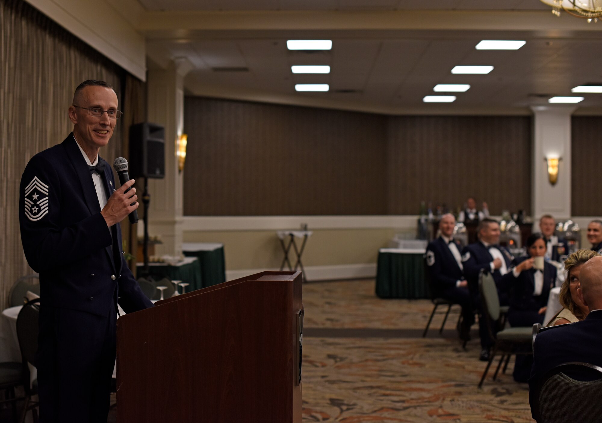 Chief Master Sgt. Lee Mills, 92nd Air Refueling Wing command chief, congratulates the 35 master sergeant selectees during the 2018 Non-Commissioned Officer Induction Ceremony at The Centennial Hotel Spokane in Spokane, Washington, Aug. 10, 2018. The new master sergeants endured a rigorous board selection process where they were evaluated and scored based on their performance, experience and accomplishments over the previous five years of their careers. (U.S. Air Force photo/Airman 1st Class Jesenia Landaverde)