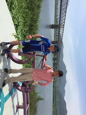 Maj. Anthony Bares, a former 28th Bomb Wing Inspector General office inspector, stands next to a sculpture of a bicycle and its creator in South Korea on May 25, 2018. Bares embarked on a four-day bicycle ride across the South Korea, following the Four Rivers Trail, which almost spans the entire length of the country. (Courtesy photo)