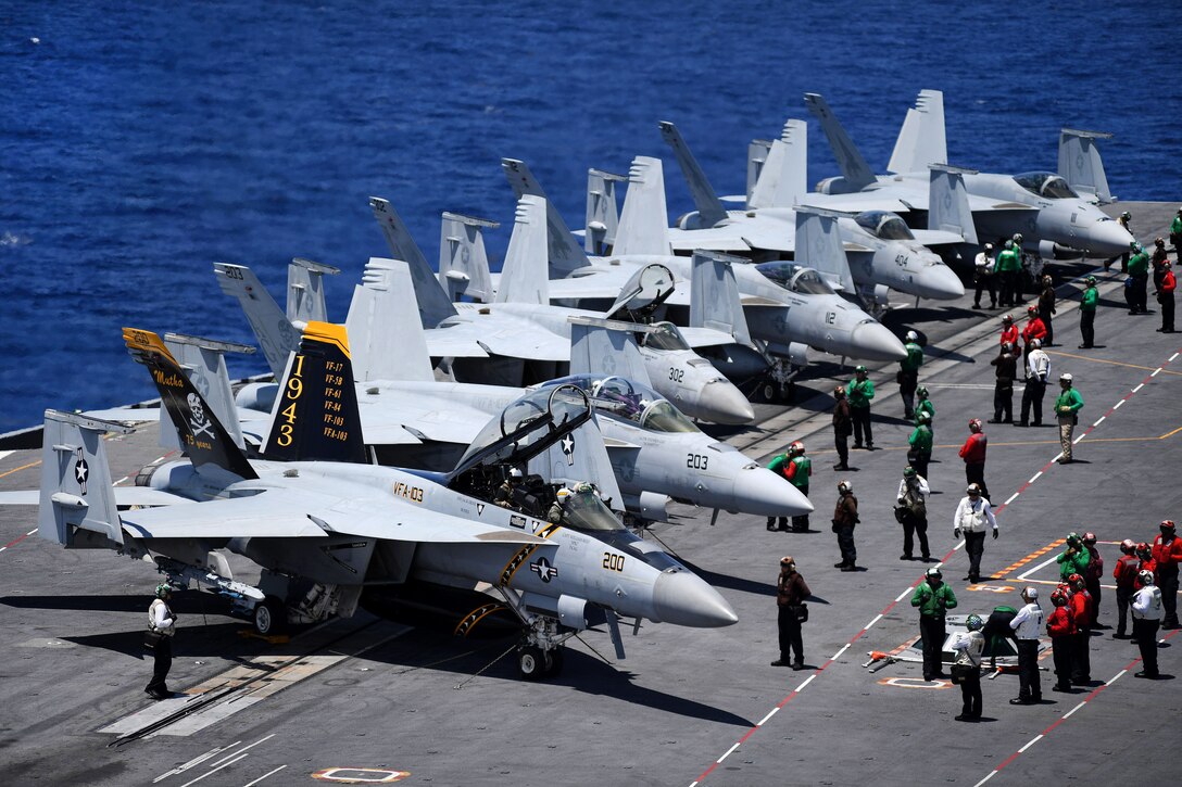 Sailors prepare aircraft for flight operations aboard the aircraft carrier USS Abraham Lincoln.