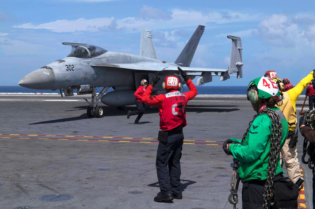 Sailors direct an F/A-18F Super Hornet aircraft during flight operations.