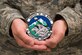 U.S. Air Force Staff Sgt. Paul Babbitt, with the 3rd Operations Support Squadron aerospace flight equipment section, holds the 3rd OSS patch he designed at Joint Base Elmendorf-Richardson, Alaska, July 12, 2018. Babbitt had the opportunity to design the new patch after squadron leadership thought an update was necessary.
