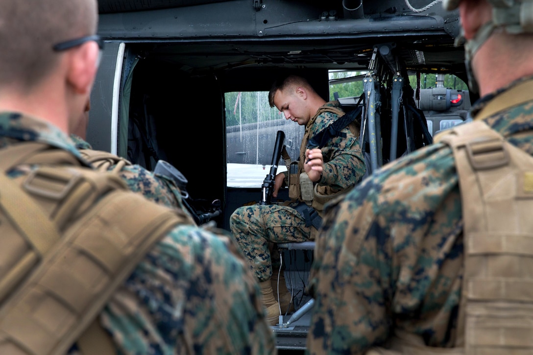 Marines practice loading onto an Army UH-60 Black Hawk helicopter.