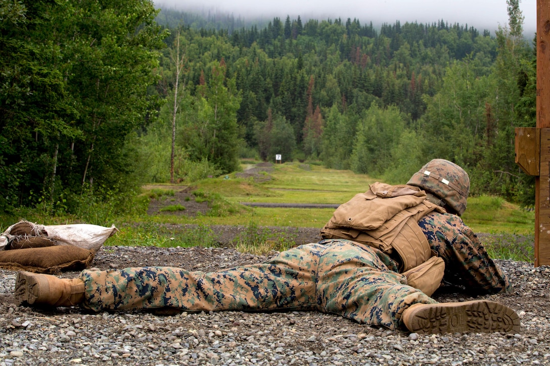 A Marine fires his rifle from the prone position.