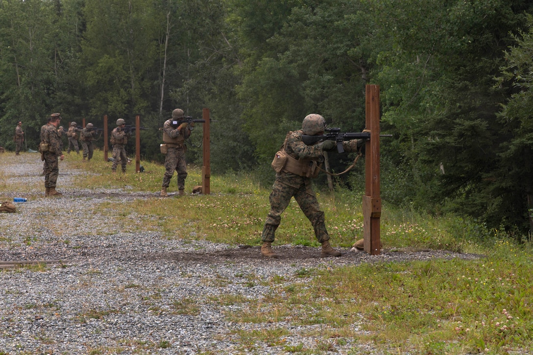 Marines fire their rifles from the standing position.