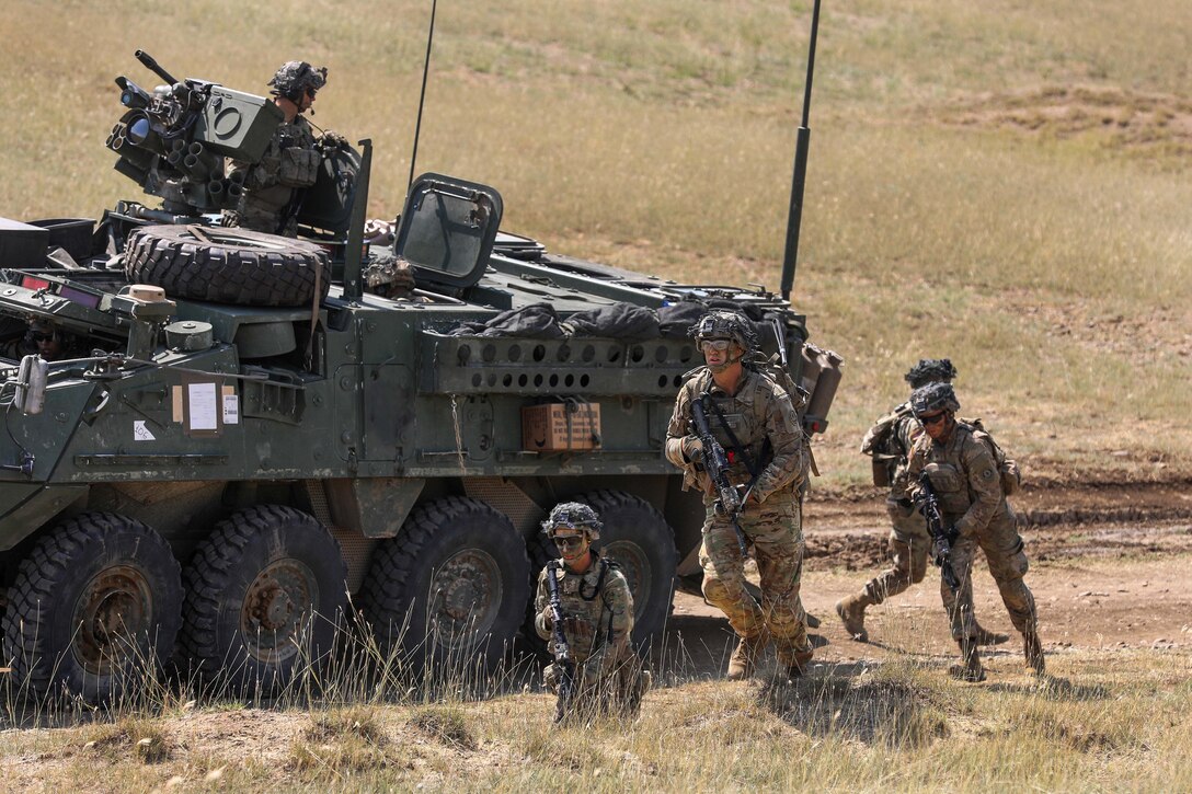 Soldiers exit a tactical vehicle.