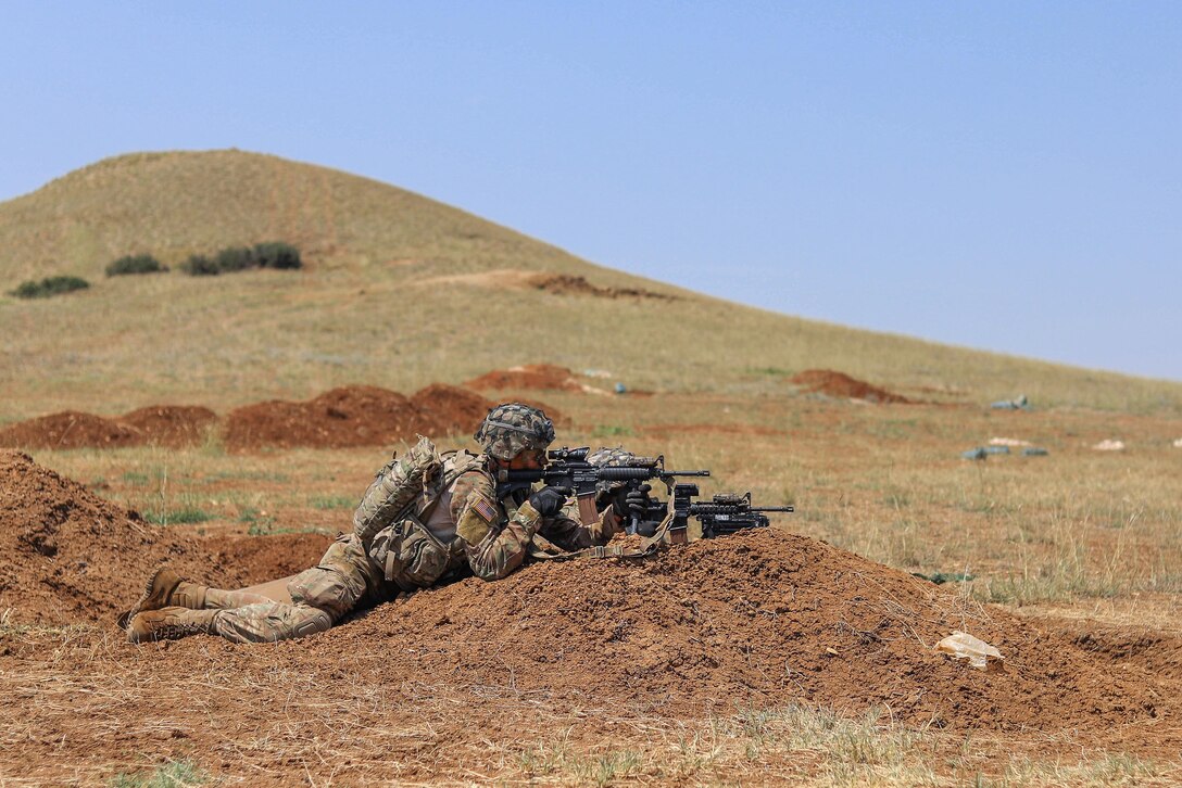 Soldiers fire their weapons at targets during a live-fire exercise.