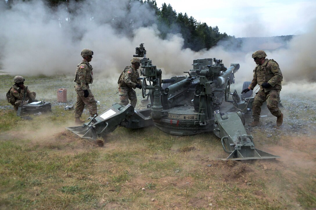 Soldiers fire an M777A2 howitzer during a live-fire exercise.