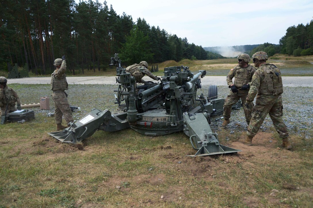Soldiers prepare to fire an M777A2 howitzer during a live-fire exercise.