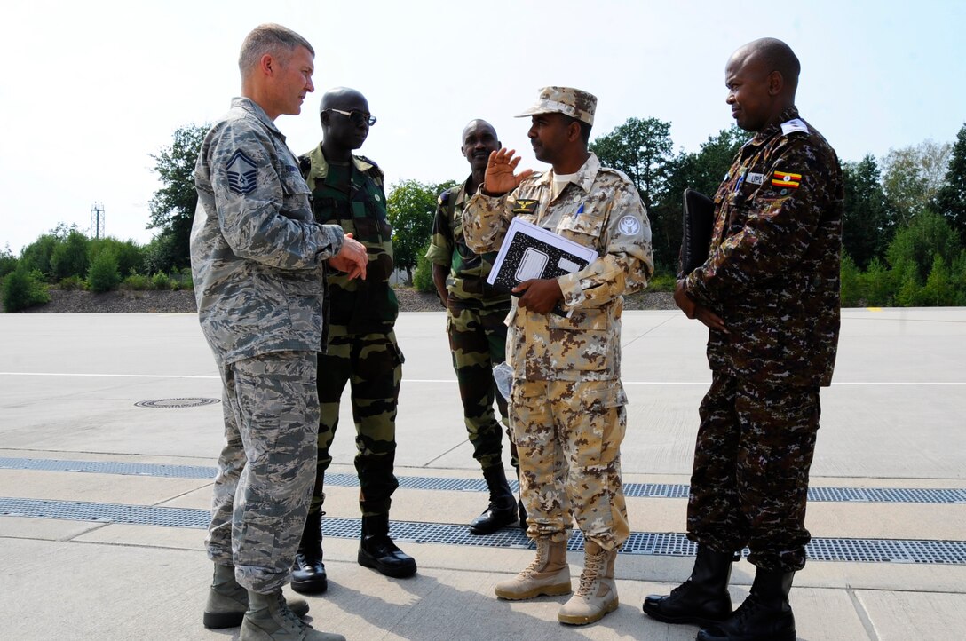 U.S. Air Force Senior Master Sgt. Ronald Robinette, Leaders Production Superintendent, assigned to 86th Air Maintenance Squadron, converses with participants of African Partnership Flight, hosted by U.S. Air Forces Africa and co-hosted by Mauritania and Senegal at Ramstein Air Base, Germany, Aug. 7, 2018. The APF program is Air Forces in Africa's premier security cooperation program with African partner nations to improve professional military aviation knowledge and skills. (U.S. Army photo by Spc. Craig Jensen)