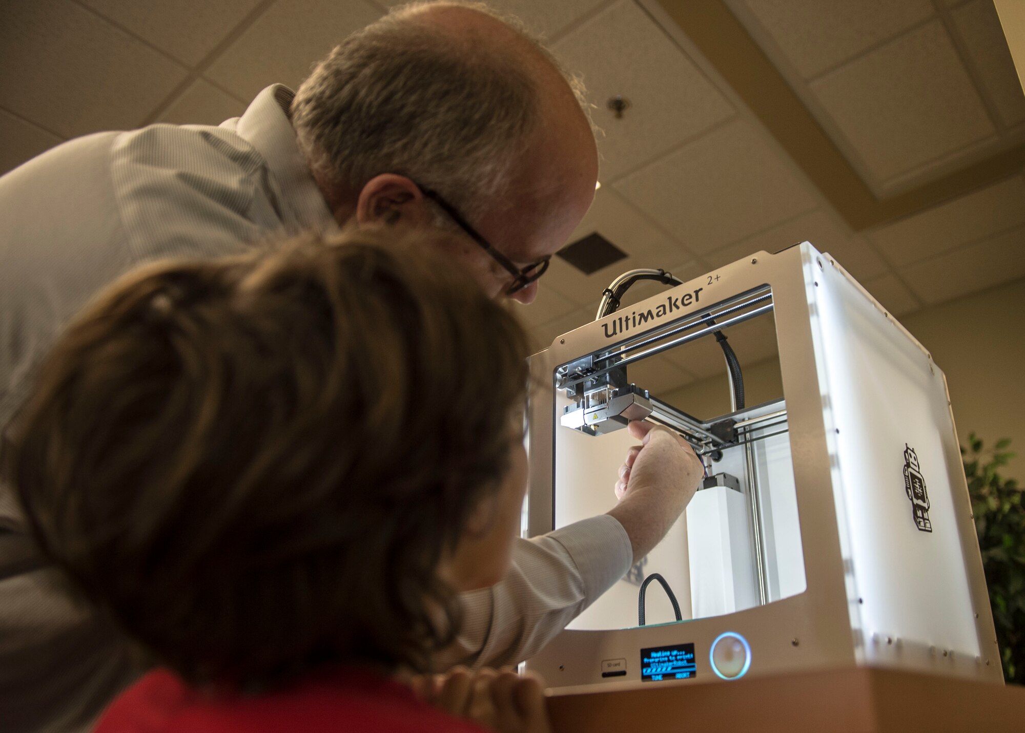 Michael Herman, 20th Force Support Squadron library director, shows a Team Shaw child the mechanics of a 3-D printer at Shaw Air Force Base, S.C., Aug. 13, 2018.