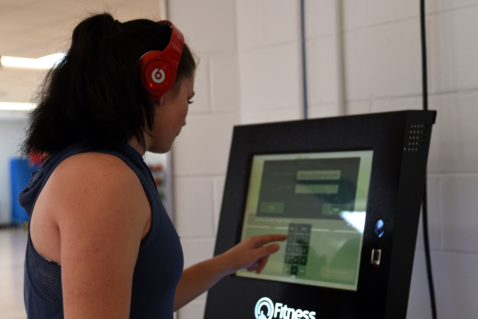 U.S. Air Force Airman 1st Class BrieAnna Stillman, 20th Fighter Wing public affairs office photojournalist journeyman, logs into the Fitness On Request kiosk at the 20th Force Support Squadron main fitness center at Shaw Air Force Base, S.C., Aug. 10, 2018.