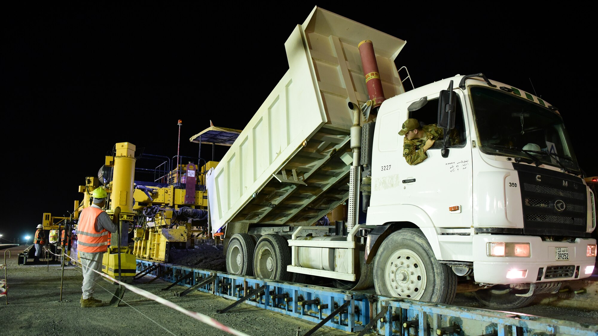 A 386th Air Expeditionary Squadron force protection Airman assists with pouring concrete July 3, 2018 at an undisclosed location in Southwest Asia. The team is pouring the concrete to finish construction on a new flight line, which will enable the 386th AEW to more effectively deliver airpower across the Air Force Central Command area of responsibility. (U.S. Air Force photo by Staff Sgt. Christopher Stoltz)
