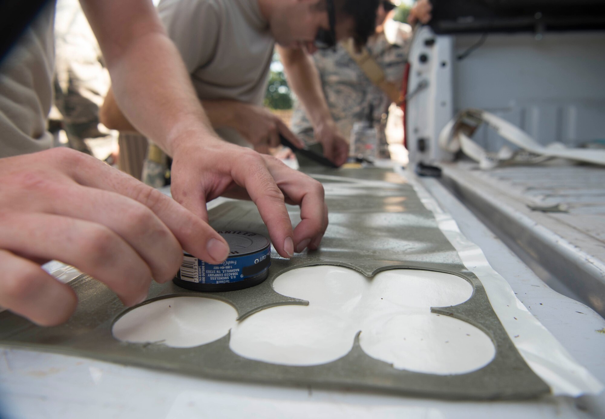 Airmen assigned to the 786th Civil Engineer Squadron Explosive Ordinance Disposal Airmen use found objects and detonating sheet explosive to create clearing charges for training on Ramstein Air Base, Germany, July 31, 2018. EOD Airmen trained to make charges out of objects available in a deployed environment, and use charges to neutralize enemy explosives. (U.S. Air Force illustration by Senior Airman Elizabeth Baker)