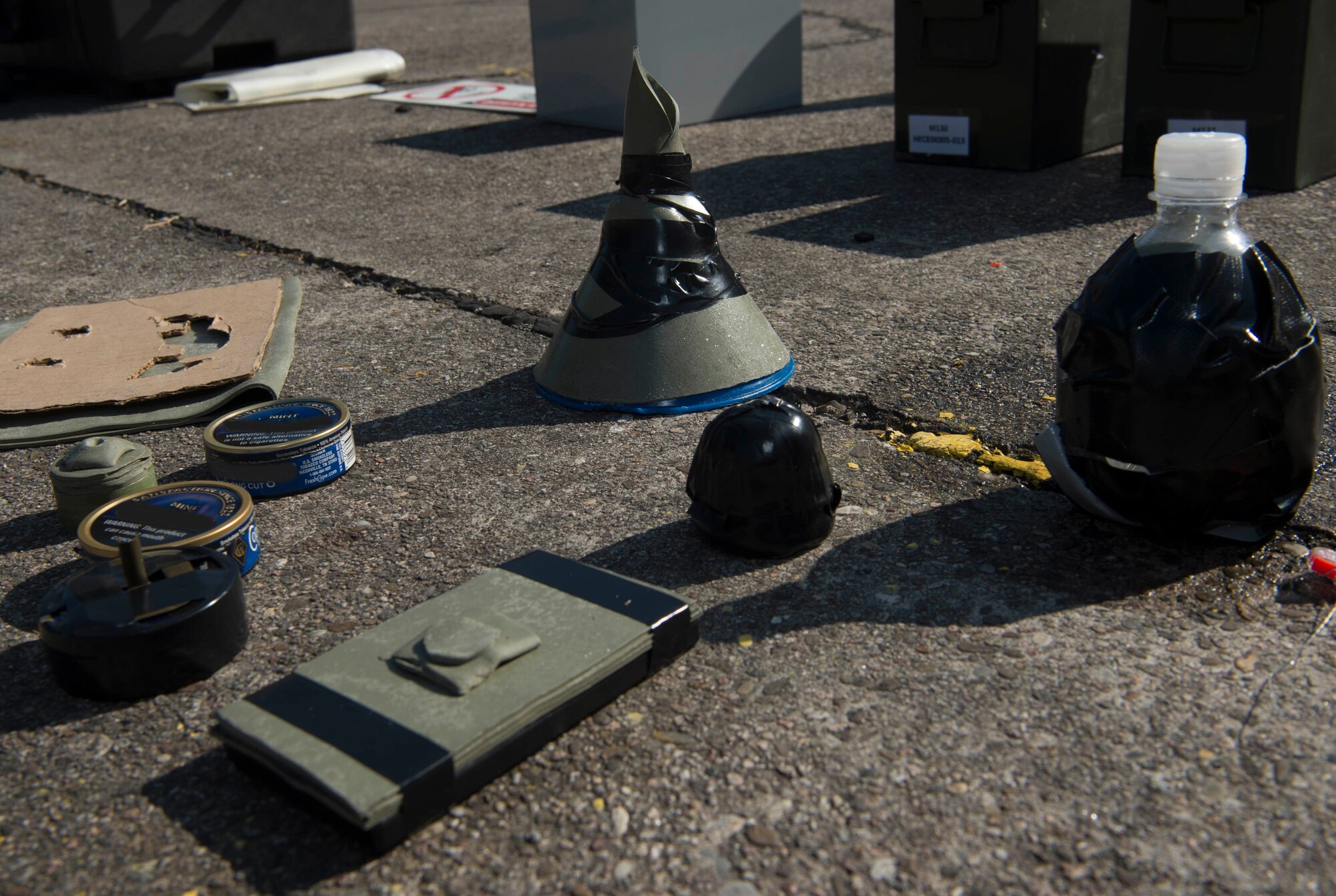 Airmen assigned to the 786th Civil Engineer Squadron Explosive Ordinance Disposal created clearing charges out of found objects during training on Ramstein Air Base, Germany, July 31, 2018. Detonating sheet explosive has a flexible texture that allows EOD Airman to use creativity, found objects, and problem solving to create charges. (U.S. Air Force illustration by Senior Airman Elizabeth Baker)