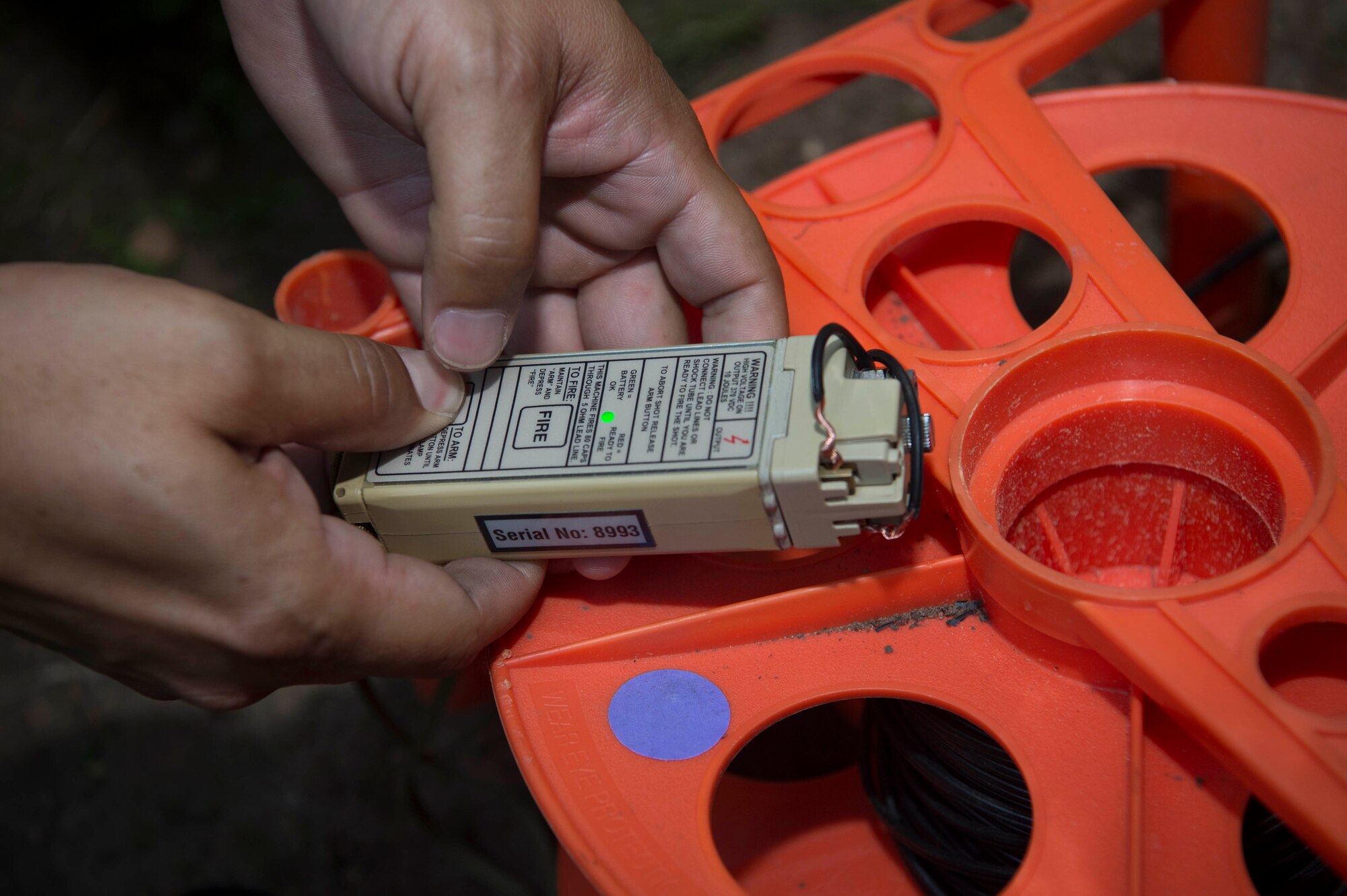 U.S. Air Force Tech. Sgt. Ricardo Porto, 786th Civil Engineer Squadron Explosive Ordinance Disposal craftsman, holds a firing device on Ramstein Air Base, Germany, July 31, 2018. EOD Airmen train to detect, disarm, detonate, and dispose of explosive threats. (U.S. Air Force photo by Senior Airman Elizabeth Baker)