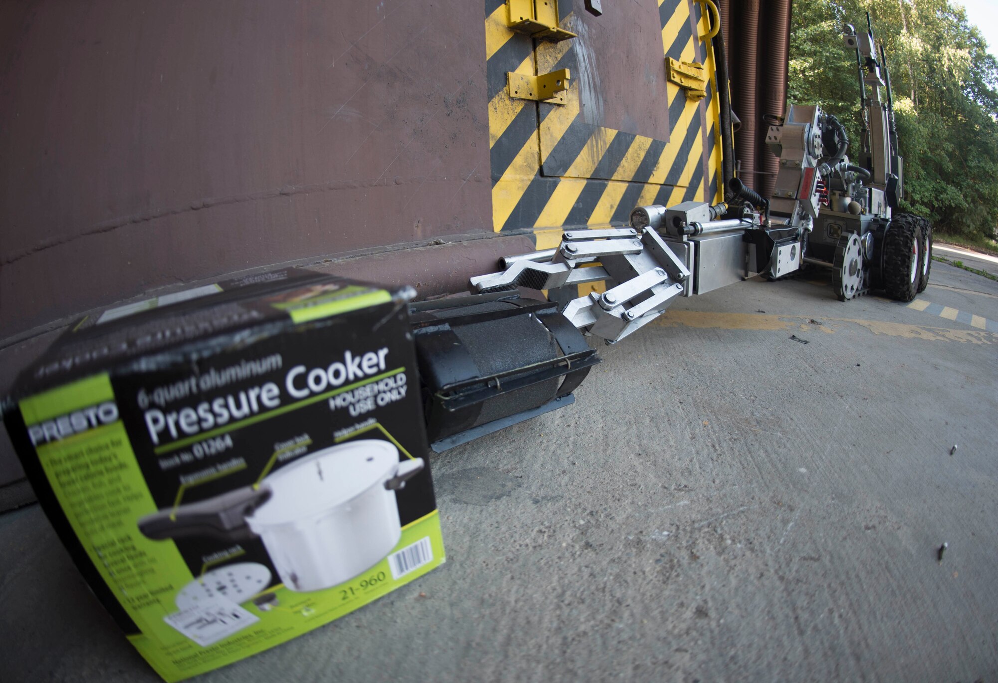 An F6A reconnaissance robot assigned to the 786th Civil Engineer Squadron Explosive Ordinance Disposal, removes a piece of metal from beside a simulated improvised explosive device on Ramstein Air Base, Germany, Aug. 2, 2018. Robots are among the many measures EOD Airmen take to ensure success and survival in a dangerous career field. (U.S. Air Force photo by Senior Airman Elizabeth Baker)