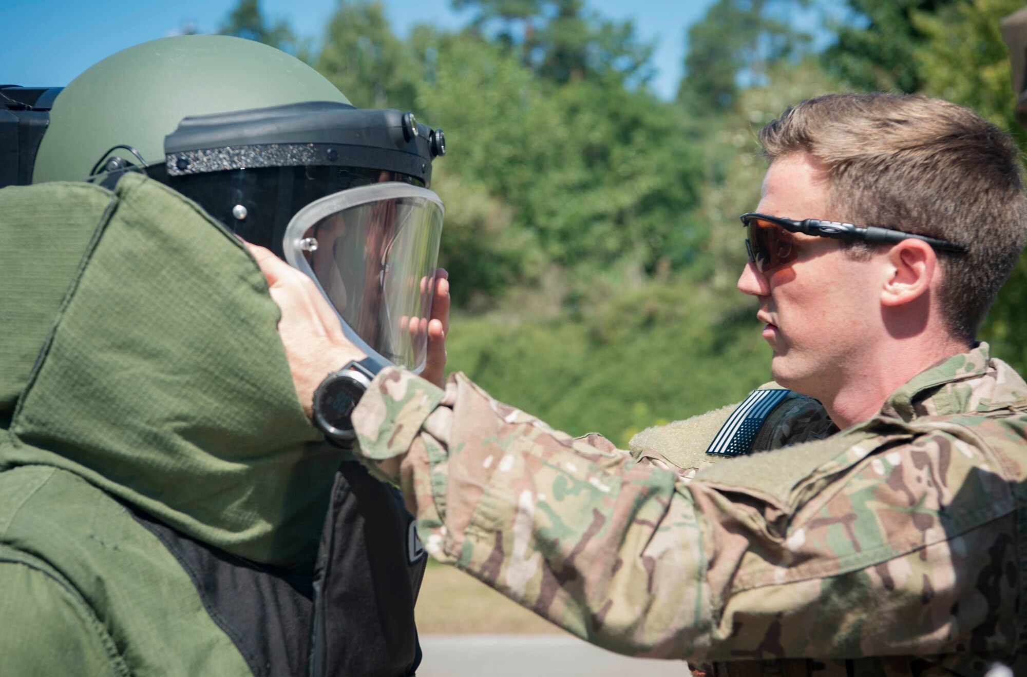 U.S. Air Force Senior Airman Jonathon McCauley, right, 786th Civil Engineer Squadron Explosive Ordinance Disposal technician, helps Staff Sgt. Jameson Baehler 786th CES EOD technician, don an EOD 9 bomb suit during training on Ramstein Air Base, Germany, Aug. 2, 2018. The suit is designed to increase the wearer's chance of survival while they are in close contact with explosives. (U.S. Air Force photo by Senior Airman Elizabeth Baker)