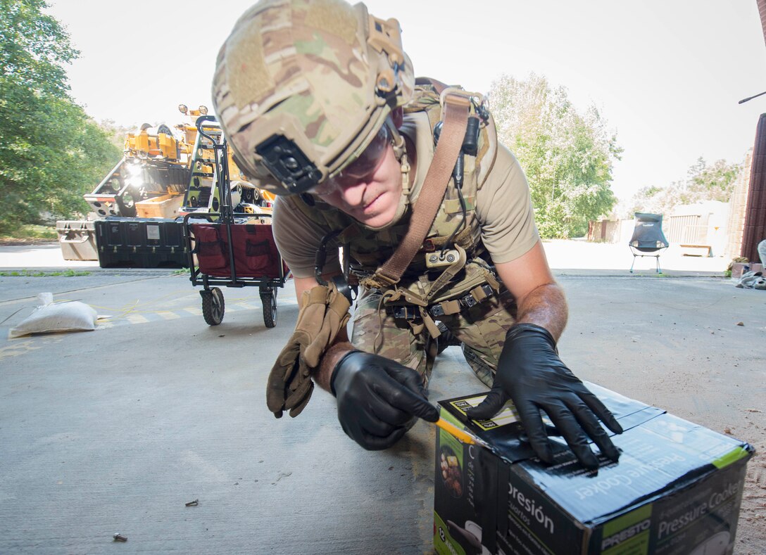 U.S. Air Force Staff Sgt. Jameson Baehler, 786th Civil Engineer Squadron Explosive Ordinance Disposal technician, opens a simulated improvised explosive device on Ramstein Air Base, Germany, Aug. 2, 2018. Whenever there is any threat or potential threat of danger from explosives on a military establishment, EOD personnel respond to diffuse the threat. (U.S. Air Force photo by Senior Airman Elizabeth Baker)