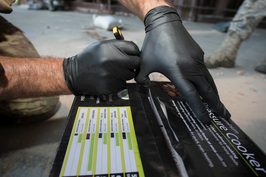 U.S. Air Force Staff Sgt. Jameson Baehler, 786th Civil Engineer Squadron Explosive Ordinance Disposal technician, opens a simulated improvised explosive device on Ramstein Air Base, Germany, Aug. 2, 2018. EOD members apply classified techniques and special procedures to lessen or remove the hazards created by the presence of unexploded ordnance. (U.S. Air Force photo by Senior Airman Elizabeth Baker)