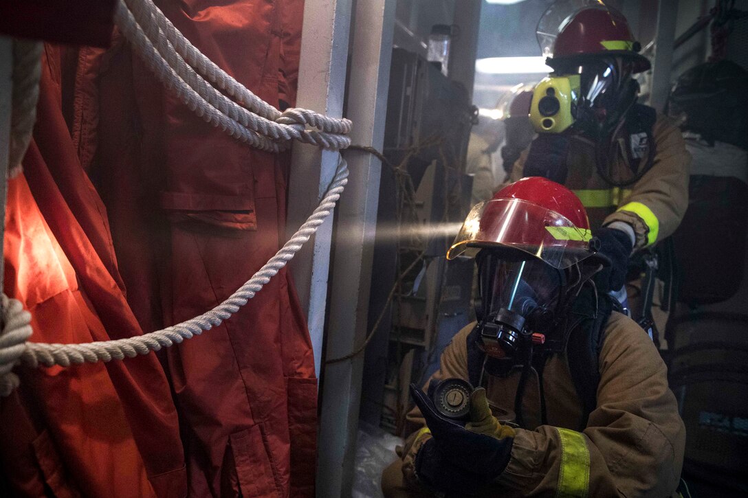Sailors combat a simulated fire during a general quarters drill.