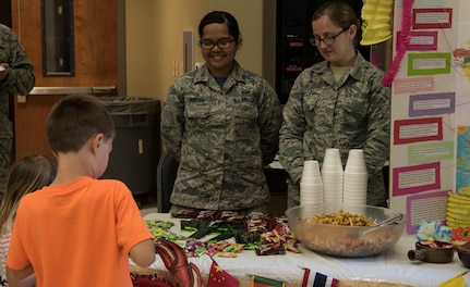 Airman 1st Class Beatrix Bainter, left, 628th Force Support Squadron force management journeyman, and Airman 1st Class Brittany Smitley, right, 437th Maintenance Squadron aerospace propulsion apprentice, manage one of the booths during Diversity Day Aug. 10, 2018, at the base Chapel Annex.