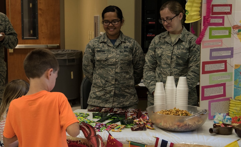 Airman 1st Class Beatrix Bainter, left, 628th Force Support Squadron force management journeyman, and Airman 1st Class Brittany Smitley, right, 437th Maintenance Squadron aerospace propulsion apprentice, manage one of the booths during Diversity Day Aug. 10, 2018, at the base Chapel Annex.