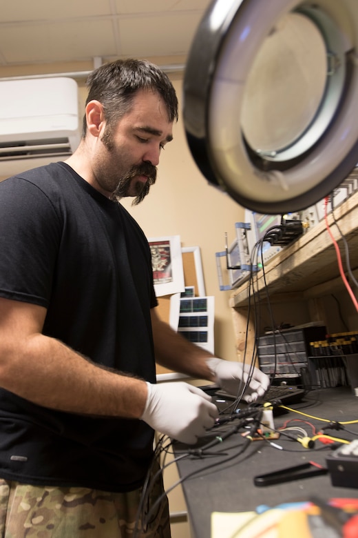 David Garcia, an electrical engineer, assigned to the Forensic Exploitation Laboratory – Central Command, analyzes a recovered piece of an improvised explosive device at Camp Arifjan, Kuwait, Aug 9, 2018. The FXL-C continually adapts and moves forward with emerging new technology to sustain our fighting force in the battleground.