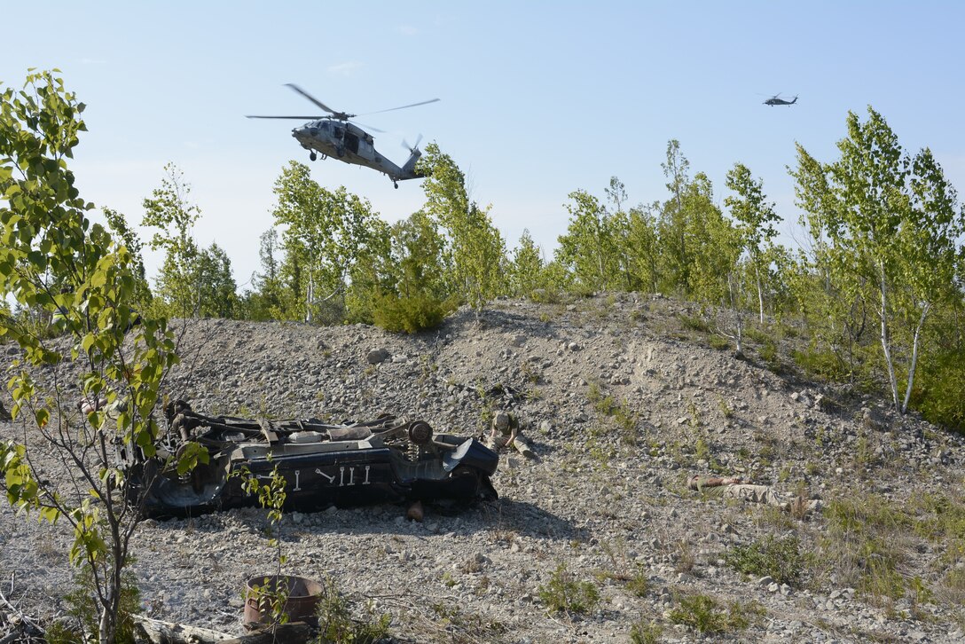 Pararescue specialists from the 103rd Pararescue Squadron, Westhampton Beach, New York, execute a rescue training mission for Northern Strike 18, Aug. 10, 2018. Northern Strike 18 is a National Guard Bureau-sponsored exercise uniting service members from many states, multiple service branches and a number of coalition countries during the first three weeks of August 2018 at the Camp Grayling Joint Maneuver Training Center and the Alpena Combat Readiness Training Center, both located in northern Michigan and operated by the Michigan National Guard. The accredited Joint National Training Capabilities exercise demonstrates the Michigan National Guard's ability to provide accessible, readiness-building opportunities for military units from all service branches to achieve and sustain proficiency in conducting mission command, air, sea, and ground maneuver integration, together with the synchronization of fires in a joint, multinational, decisive action environment. (Air National Guard photo by Airman 1st Class Tiffany Clark).