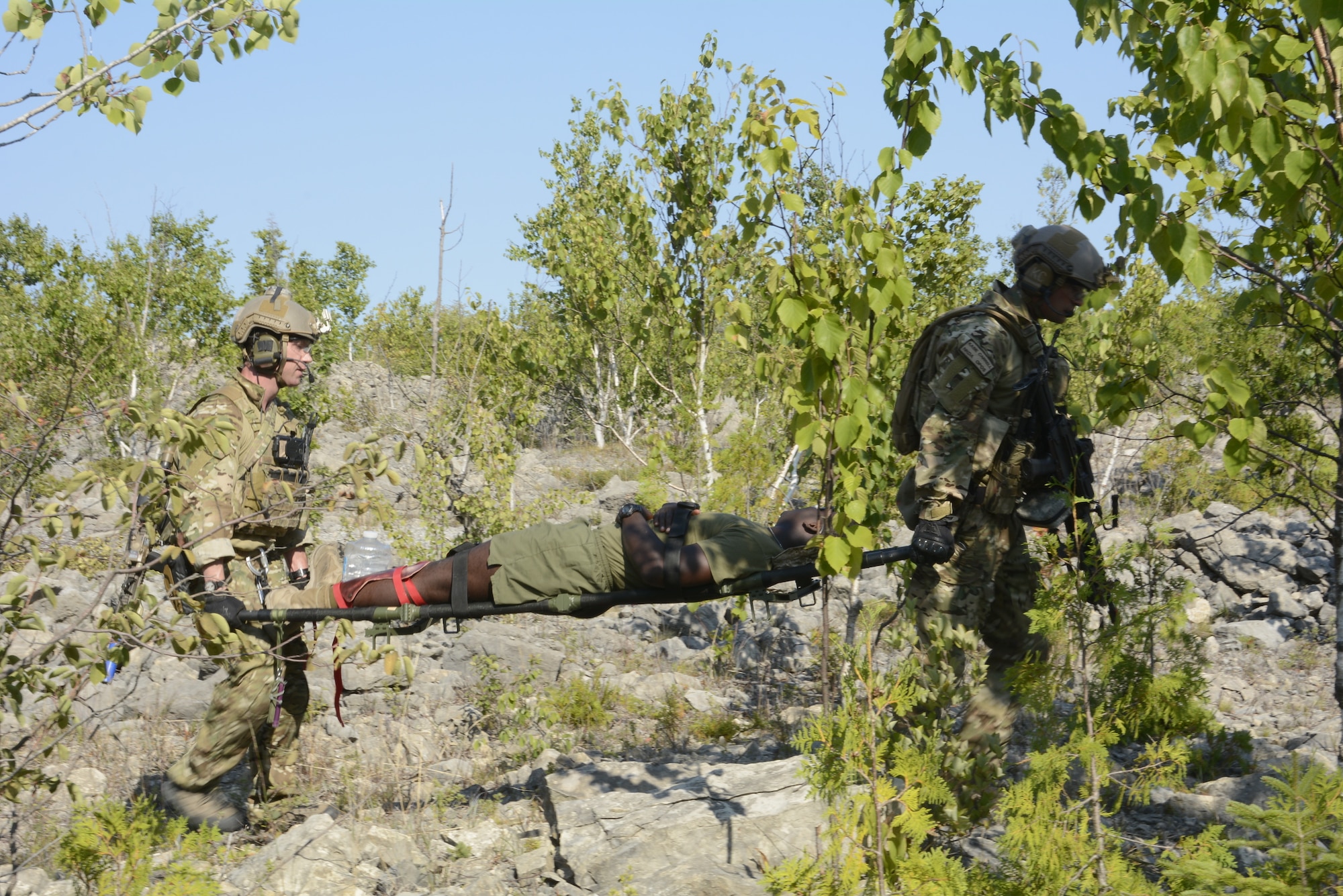 Pararescue specialists from the 103rd Pararescue Squadron, Westhampton Beach, New York, execute a rescue training mission for Northern Strike 18, Aug. 10, 2018. Northern Strike 18 is a National Guard Bureau-sponsored exercise uniting service members from many states, multiple service branches and a number of coalition countries during the first three weeks of August 2018 at the Camp Grayling Joint Maneuver Training Center and the Alpena Combat Readiness Training Center, both located in northern Michigan and operated by the Michigan National Guard. The accredited Joint National Training Capabilities exercise demonstrates the Michigan National Guard's ability to provide accessible, readiness-building opportunities for military units from all service branches to achieve and sustain proficiency in conducting mission command, air, sea, and ground maneuver integration, together with the synchronization of fires in a joint, multinational, decisive action environment. (Air National Guard photo by Airman 1st Class Tiffany Clark)