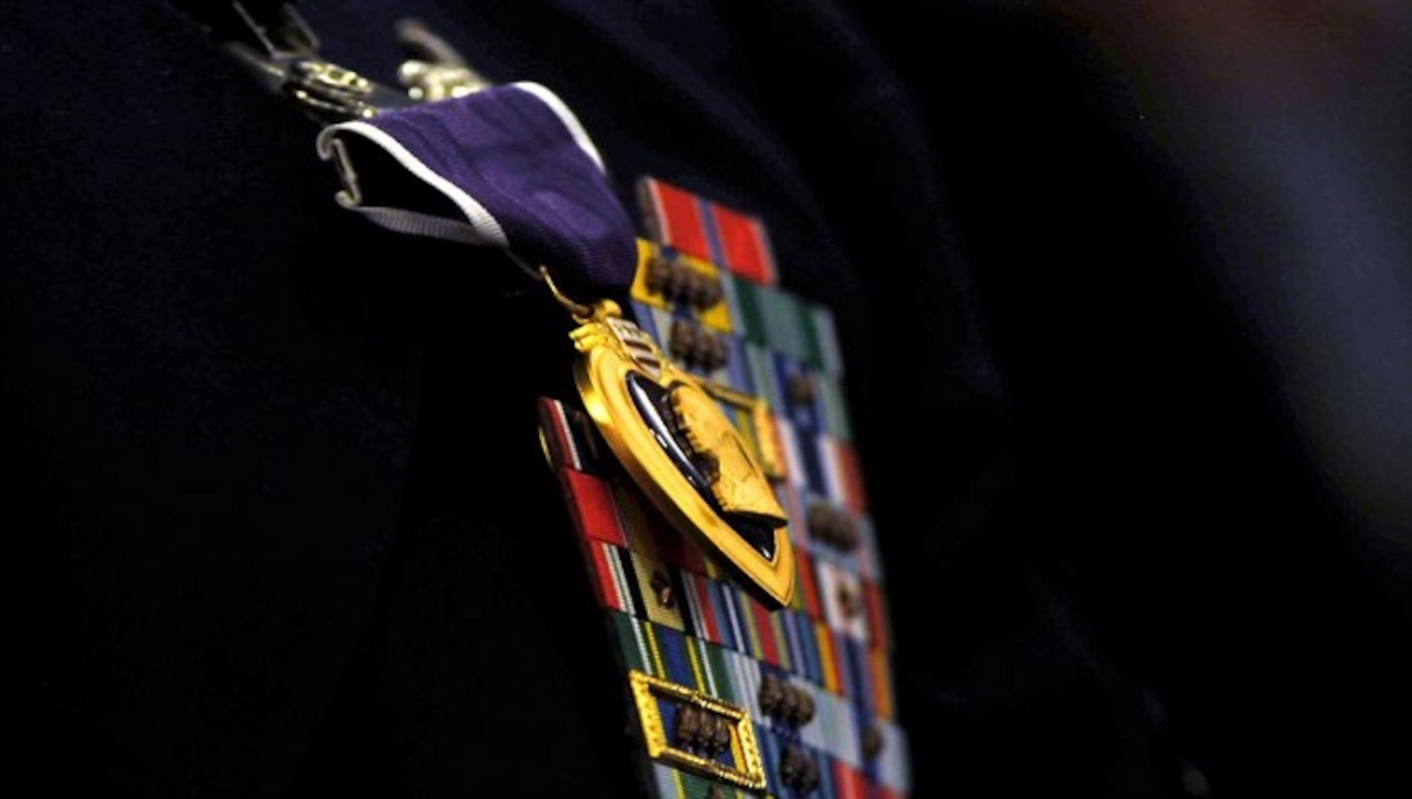 (Former) Chairman of the Joint Chiefs of Staff, Gen. Martin E. Demplsey presents the Purple Heart medal to (then) Tech. Sgt. Richard Chwalik, Dec. 19, 2011 at a town hall meeting during the chairman's visit to Ramstein Air Base, Germany. Chwalik was injured during his deployment to Afghanistan in 2009. (U.S. Air Force photo by Tech. Sgt. Markus M. Maier)