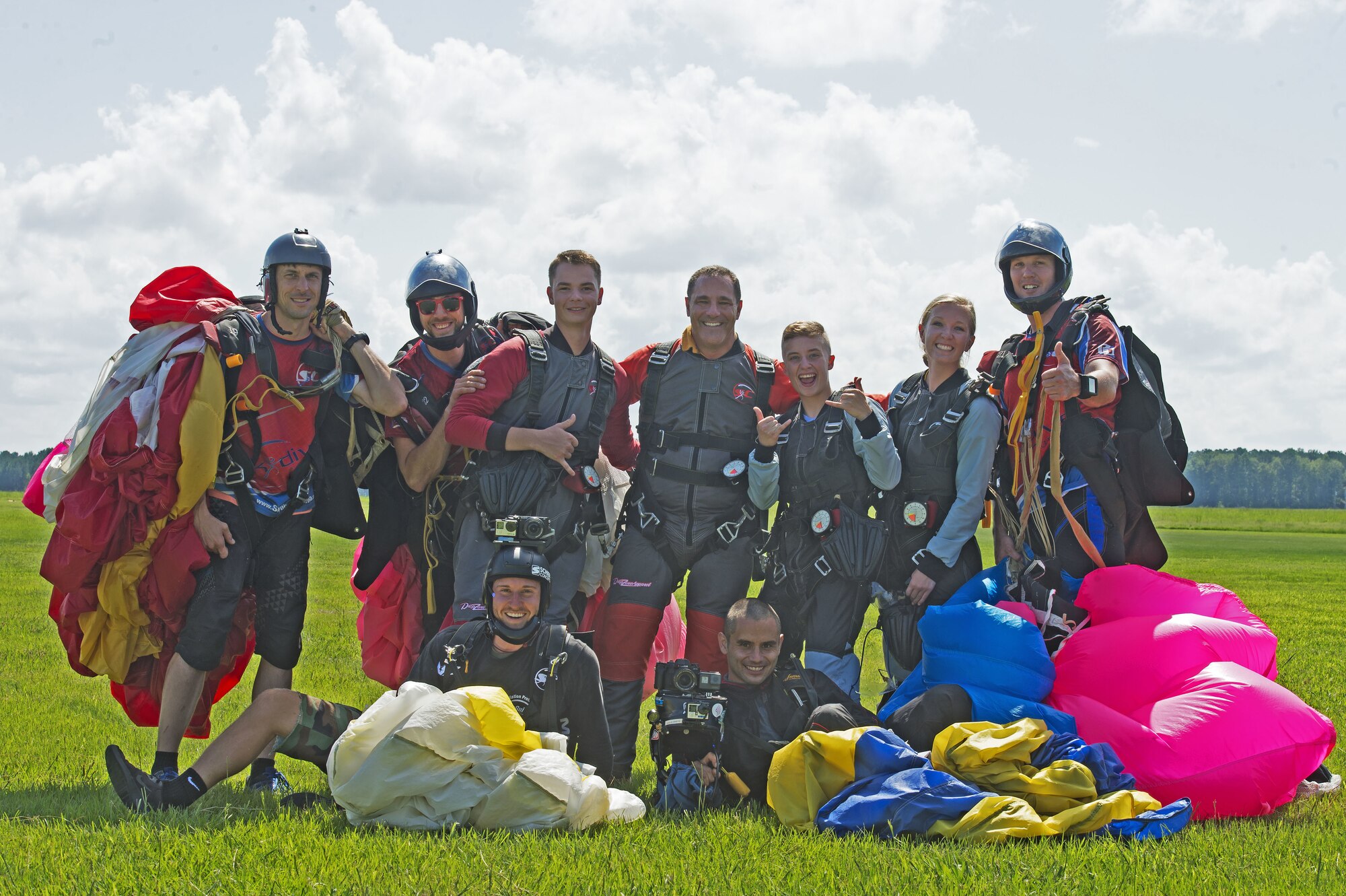 U.S. Air Force Team Shaw Airmen pose with their tandem skydiving instructors in Chester, S.C., Aug. 11, 2018.