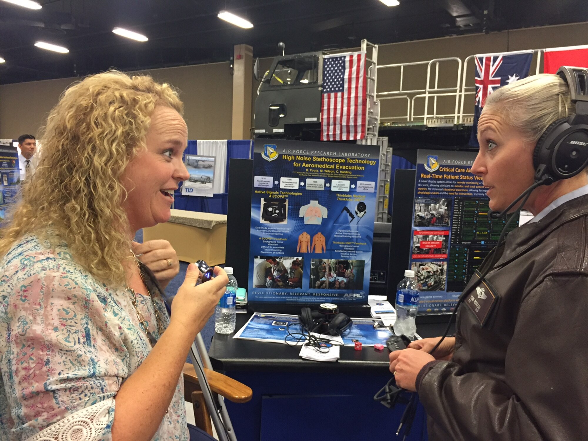 Melissa Wilson (left), a nurse research scientist with the 711th Human Performance Wing at Wright-Patterson Air Force Base, Ohio, demonstrates the noise-immune stethoscope to Col. Tami Rougeau, Individual Mobilization Augmentee to the director of  healthcare operations, Air Force Medical Support Agency, October 2016, Nashville, Tenn. The noise-immune stethoscope would improve on traditional stethoscopes as it would account for the challenging noise environments associated with en route care. (Courtesy photo)