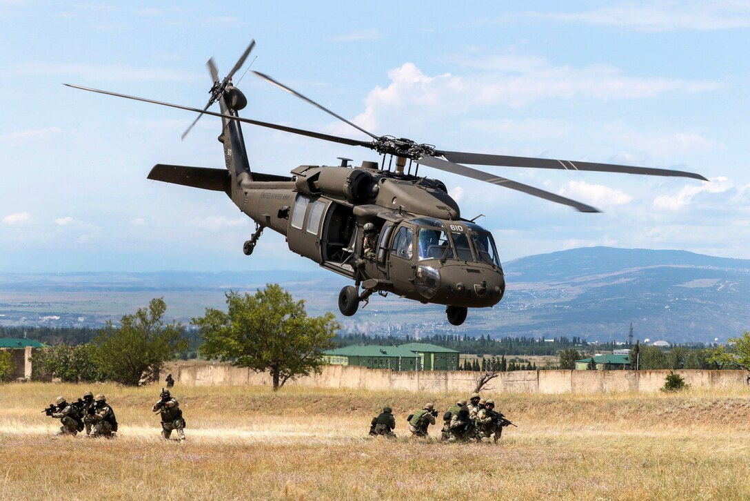 An Army UH-60 Black Hawk helicopter takes off.