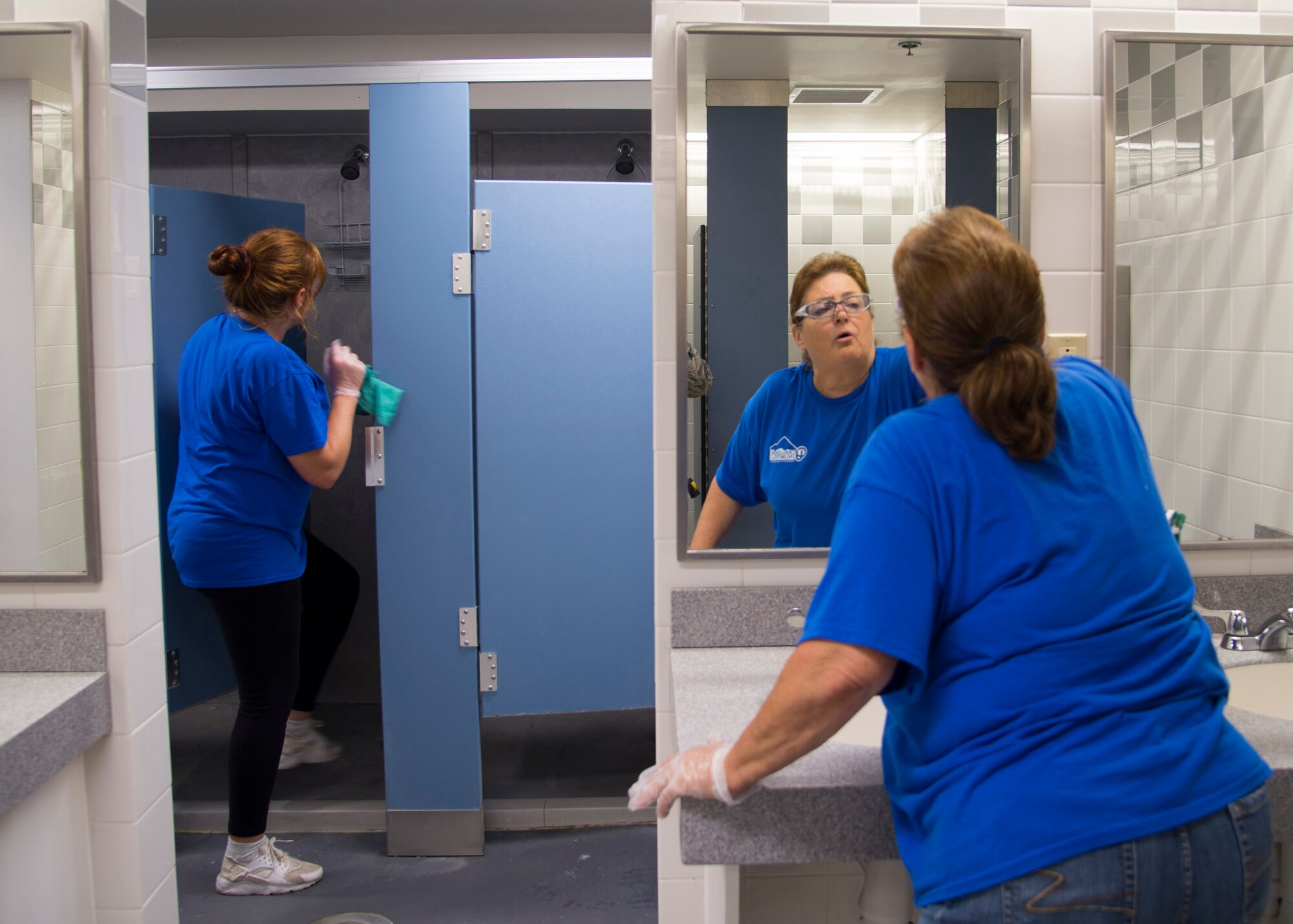 Dawn D., Challenge Unlimited employee, and Cyndi G., Challenge Unlimited supervisor clean a locker room at James Gym, Aug. 13, 2018, at Scott Air Force Base, Illinois.