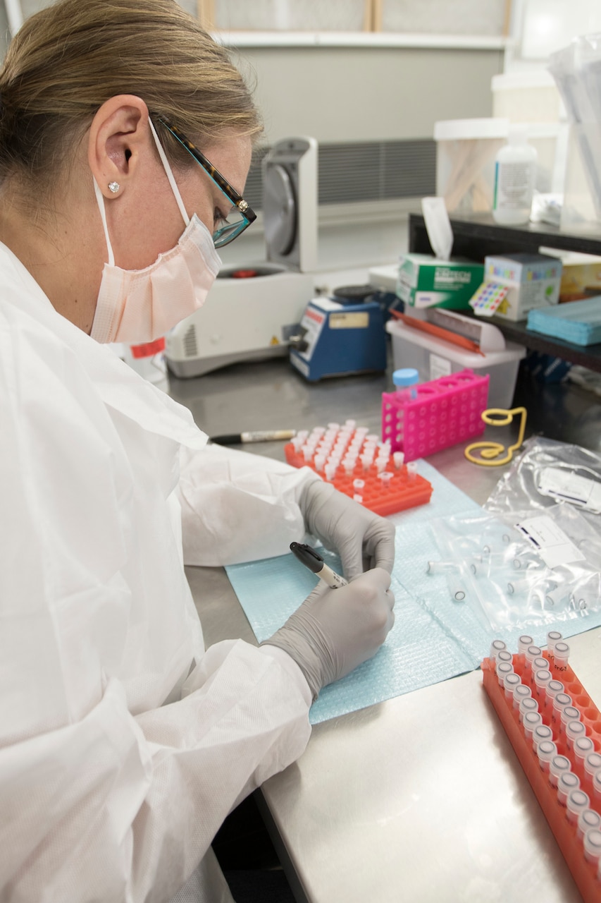 Ms. Denise Myers, a DNA analyst, assigned to the Forensic Exploitation Laboratory – Central Command, labels containers which hold samples recovered from an item that will generate a DNA profile for a person of interest, Aug. 9, 2018, at Camp Arifjan, Kuwait. The capabilities of the FXL-C provide critical intelligence to our combat forces on ground.