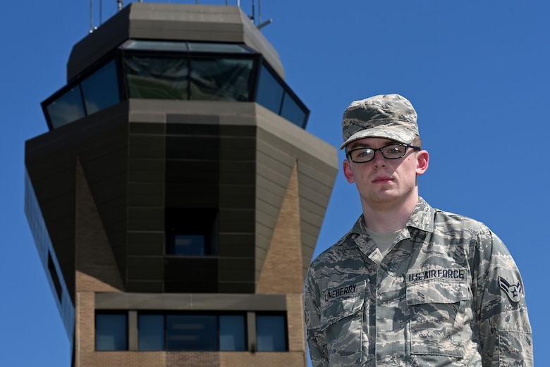 U.S. Air Force Airman 1st Class Austin Lineberry, 20th Operations Support Squadron air traffic control apprentice, stands in front of the air traffic control tower at Shaw Air Force Base, S.C., Aug. 10, 2018.