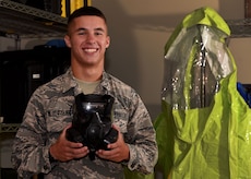 U.S. Air Force Airman Jacob Mlodozeniec, 20th Aerospace Medicine Squadron bioenvironmental engineer apprentice, holds a gas mask at Shaw Air Force Base, S.C., Aug. 10, 2018.