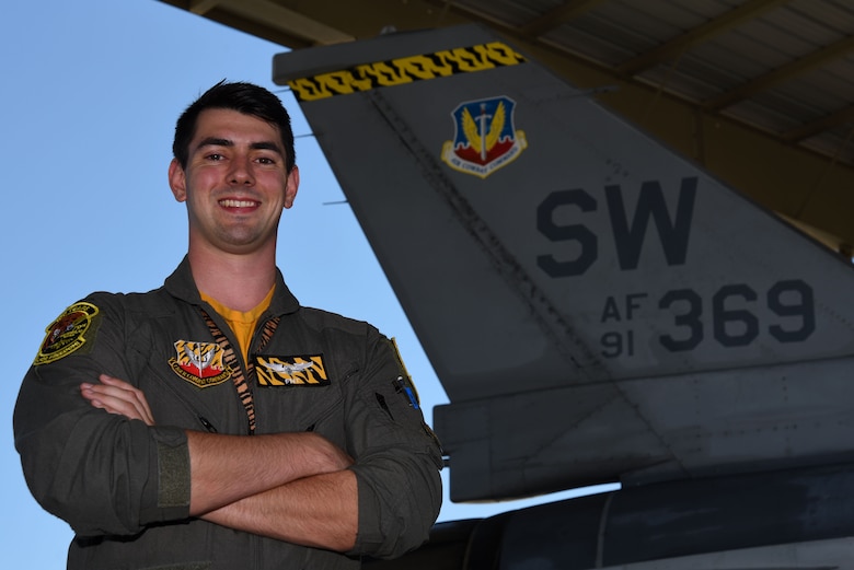 U.S. Air Force 1st Lt. Mitch Greene, 79th Fighter Squadron F-16CM Fighting Falcon pilot, stands beside an F-16 at Shaw Air Force Base, S.C., Aug. 10, 2018.