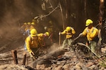 Air National Guard airmen fight a wildfire.